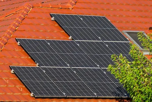Solar panels installed on a clay tile residential roof